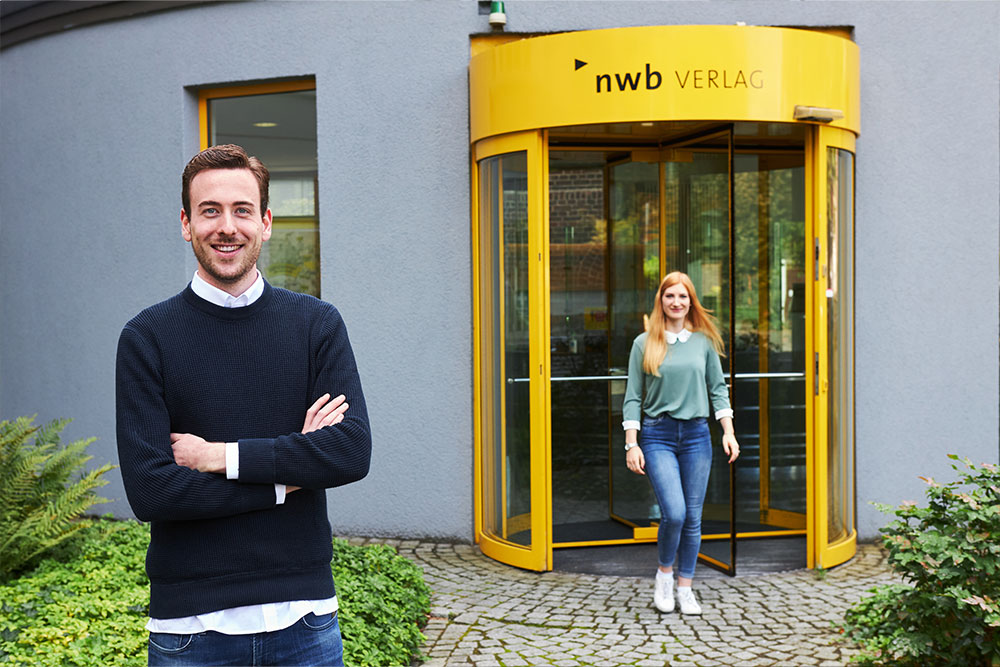 NWB Verlag Eingang, Mann, Frau, lächelnd, optimistisch